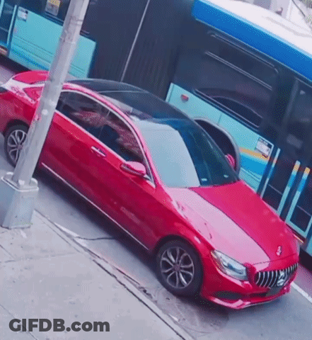 Red Car Parked In Front Of Blue Bus GIF