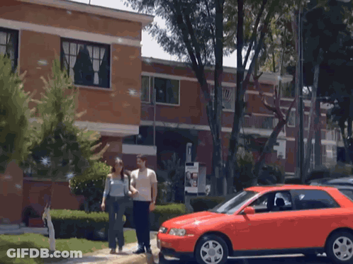 Red Car Parked In Front Of Building GIF