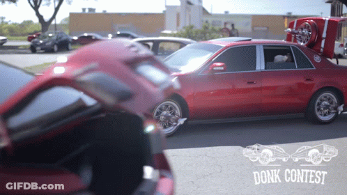 Red Car Parked In Front Of Donk Contest Sign GIF