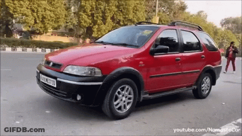 Red Car Parked With M License Plate GIF
