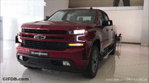 Red Chevrolet Silverado Pickup Truck In Showroom GIF