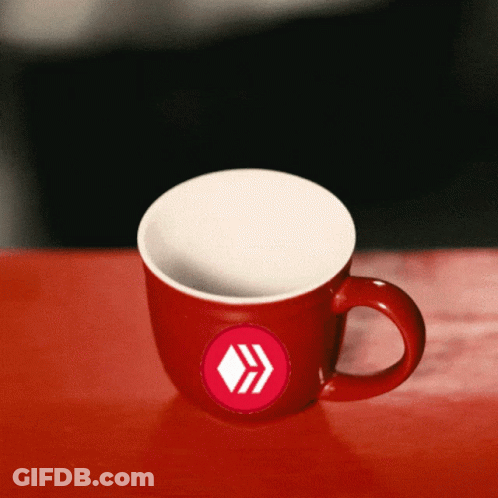 Red Coffee Mug With White Arrow On Red Table GIF
