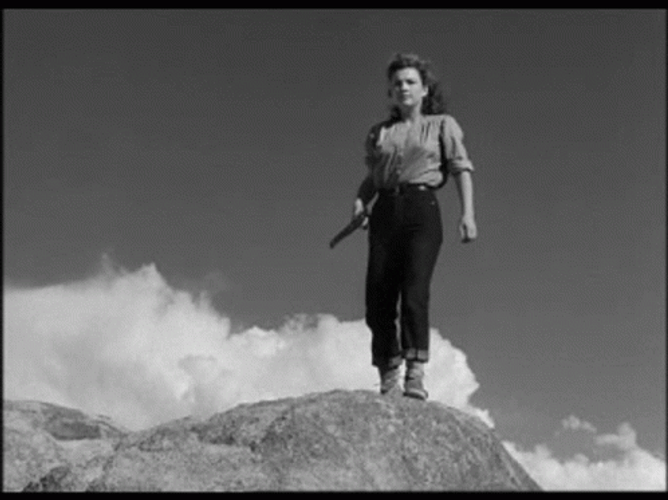 Red Dawn Girl At Top Of Rock GIF