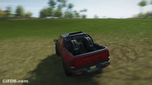 Red Dodge Ram Driving Through Grassy Field GIF