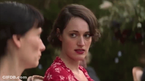 Red Dress Woman Looking At Camera With Another Woman GIF