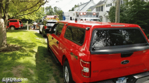 Red Ford Truck Parked Next To White Ambulance GIF