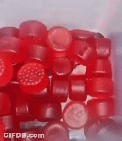 Red Gummies Inside Plastic Jar GIF