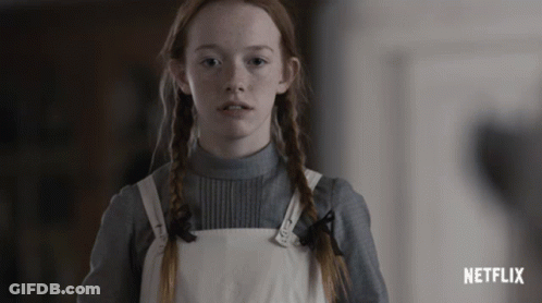 Red Hair Girl Standing In Front Of Netflix Ad GIF