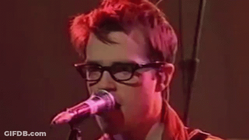 Red Hair Man With Glasses Singing Into Microphone GIF