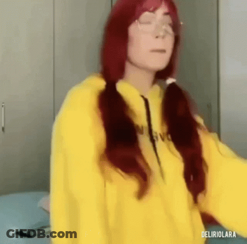 Red Hair Woman In Yellow Hoodie Standing On Bed GIF