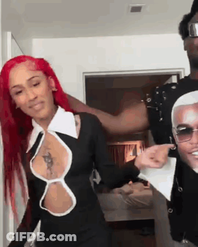 Red Hair Woman Next To Man In Sunglasses And Black Dress GIF