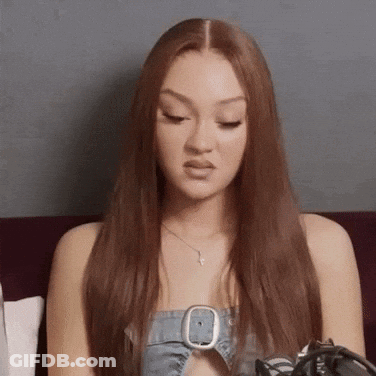 Red Hair Woman On Couch In Denim Top GIF