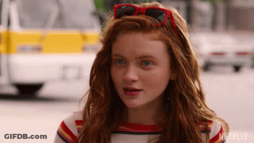 Red-Haired Girl With Sunglasses On Head GIF