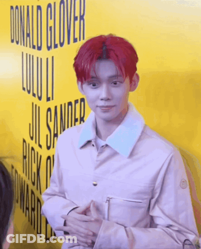 Red-Haired Man In Front Of Yellow Donald Glover Sign GIF