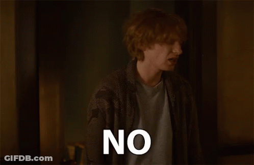 Red-Haired Man Saying No In Dark Room GIF