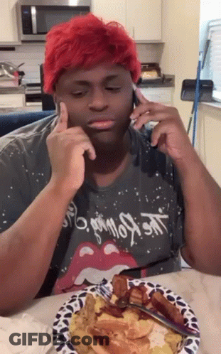 Red-Haired Man Sitting At Table With Food And Cell Phone GIF
