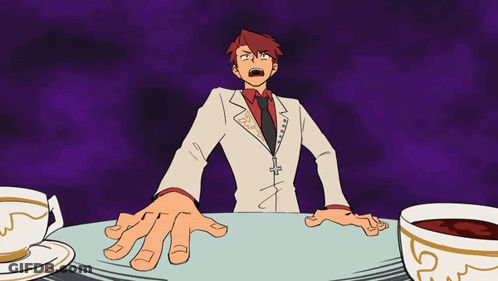Red-Haired Man Sitting At Table With Two Coffees GIF