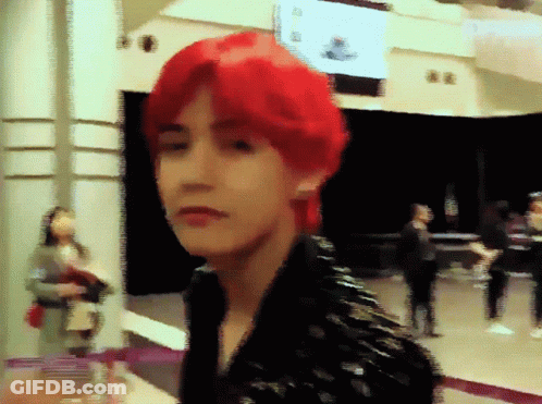 Red-Haired Man Standing In Front Of Sign Saying A GIF