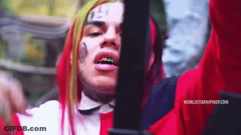 Red Haired Man With Face Tattoo Holding Gun GIF