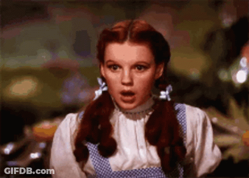 Red-Haired Pigtailed Woman In Blue Polka Dot Dress GIF