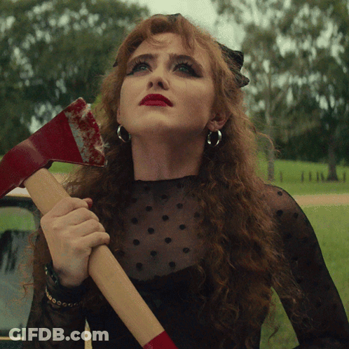 Red-Haired Woman Holding Bloody Axe GIF