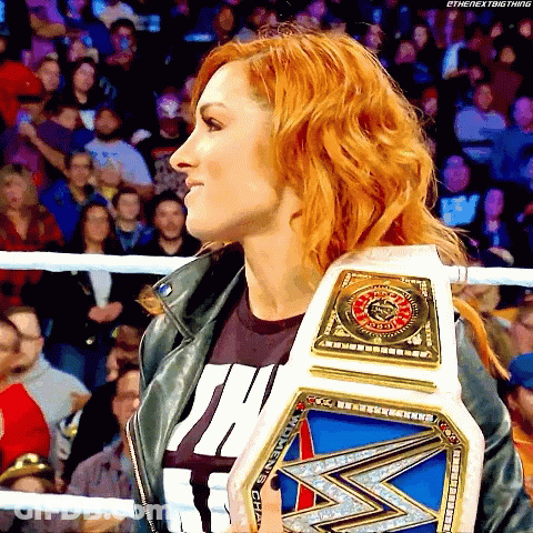 Red-Haired Woman Holding Wrestling Championship Belt GIF