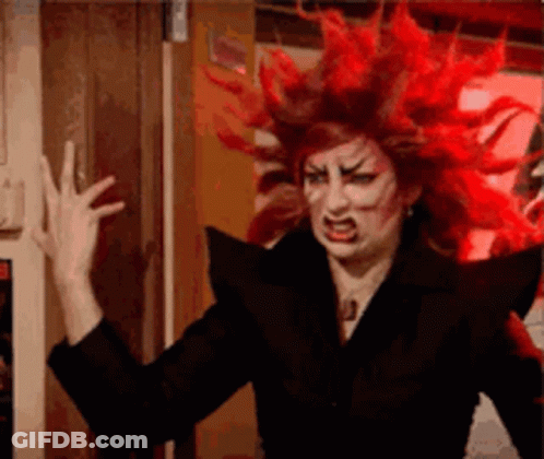 Red Haired Woman In Black Jacket Making Face GIF