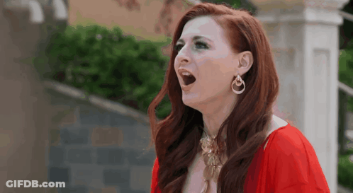 Red-Haired Woman In Earrings And Red Dress GIF