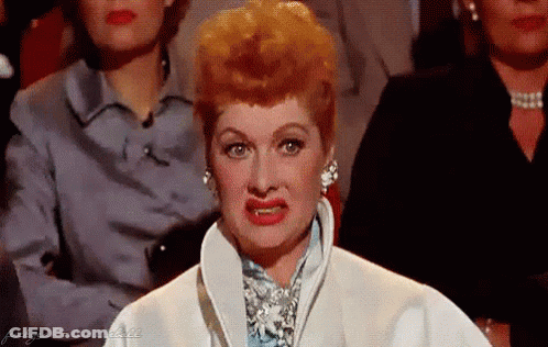 Red-Haired Woman In White Coat Making Funny Face GIF