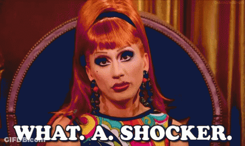 Red-Haired Woman Sitting In Chair Saying What A Shocker GIF