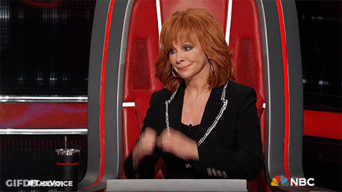 Red-Haired Woman Sitting In NBC Chair GIF