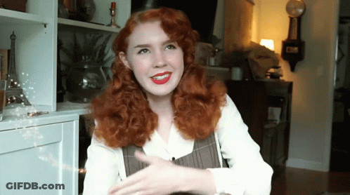 Red-Haired Woman Smiling At Clock Saying Clock GIF