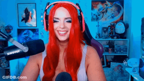 Red-Haired Woman Smiling At Microphone GIF