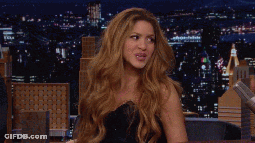 Red-Haired Woman Smiling At Night Skyline GIF