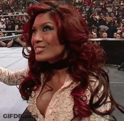 Red-Haired Woman Smiling Before Crowd GIF