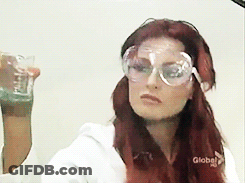 Red-Haired Woman Wearing Goggles Holding Glass GIF