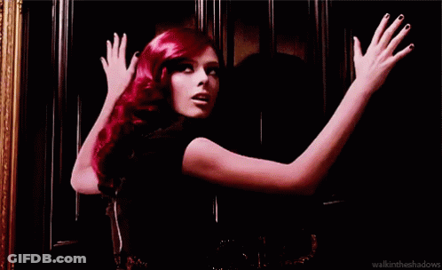 Red-Haired Woman With Arms Outstretched At Door GIF