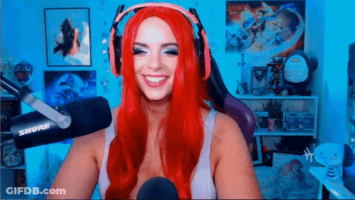 Red-Haired Woman With Headphones Smiling At Microphone GIF