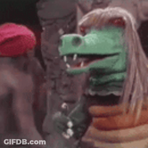 Red Hat Man Next To Dinosaur Puppet GIF