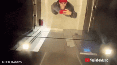 Red Hat Man Selfie With YouTube Music Logo GIF