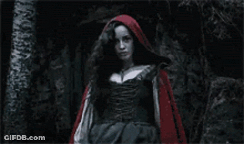 Red Hooded Woman Standing In Dark GIF