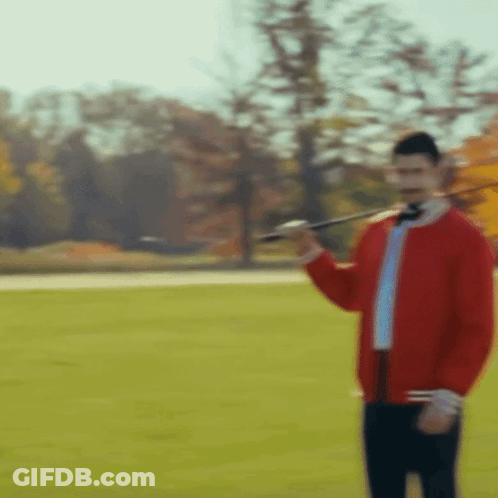 Red Jacket Man Holding Sword In Field GIF