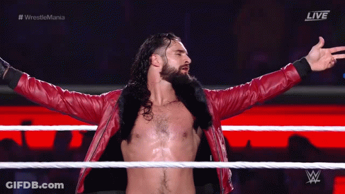 Red Jacket Wrestler Arms Outstretched In Ring GIF