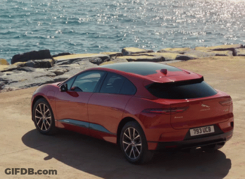 Red Jaguar I-Pace Near Ocean GIF