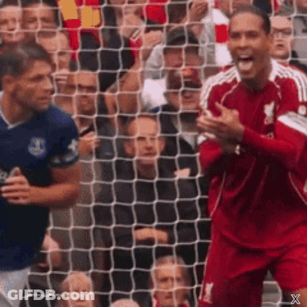Red Jersey Player Celebrating Goal Blue Player Watching GIF