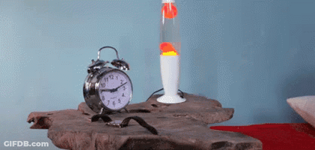 Red Lava Lamp Besides Alarm Clock GIF
