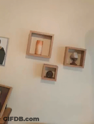 Red Letter L Hanging Next To Picture GIF