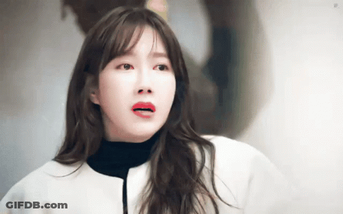 Red-Lipped Woman In White Jacket And Black Turtleneck GIF