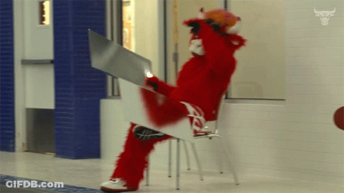 Red Mascot Sitting On Chair Holding White Board GIF