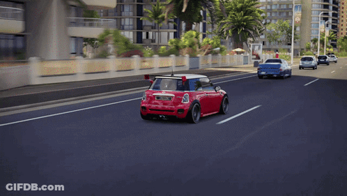 Red Mini Cooper With License Plate JCW Driving Down Street GIF
